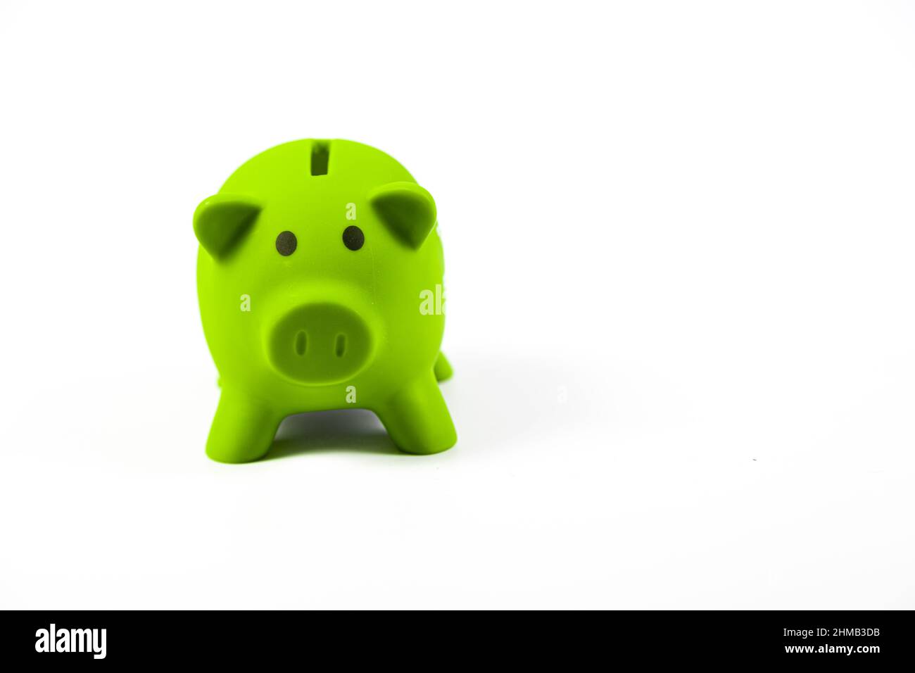 green piggy bank on white background isolated Stock Photo - Alamy