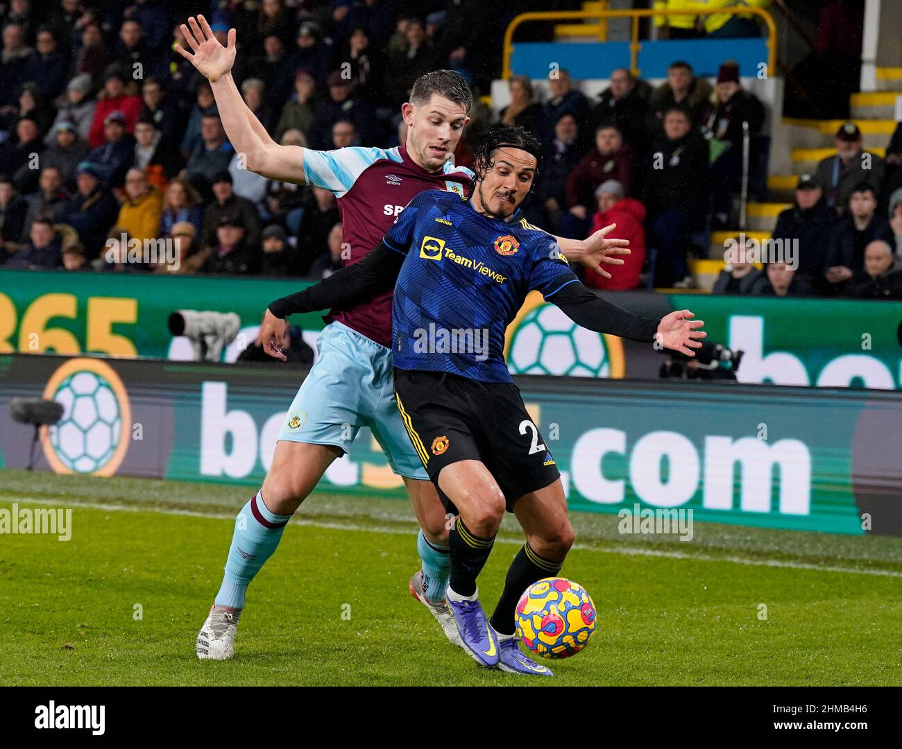 Burnley, England, 8th February 2022.   James Tarkowski of Burnley challenges Edinson Cavani of Manchester United during the Premier League match at Turf Moor, Burnley. Picture credit should read: Andrew Yates / Sportimage Stock Photo