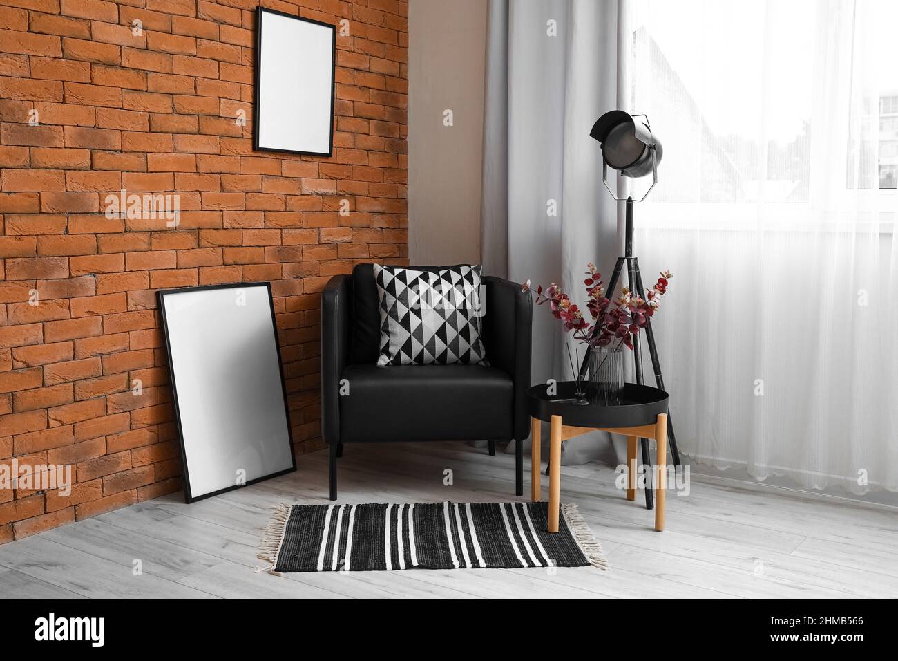 Interior of modern living room with black armchair, standing lamp and ...