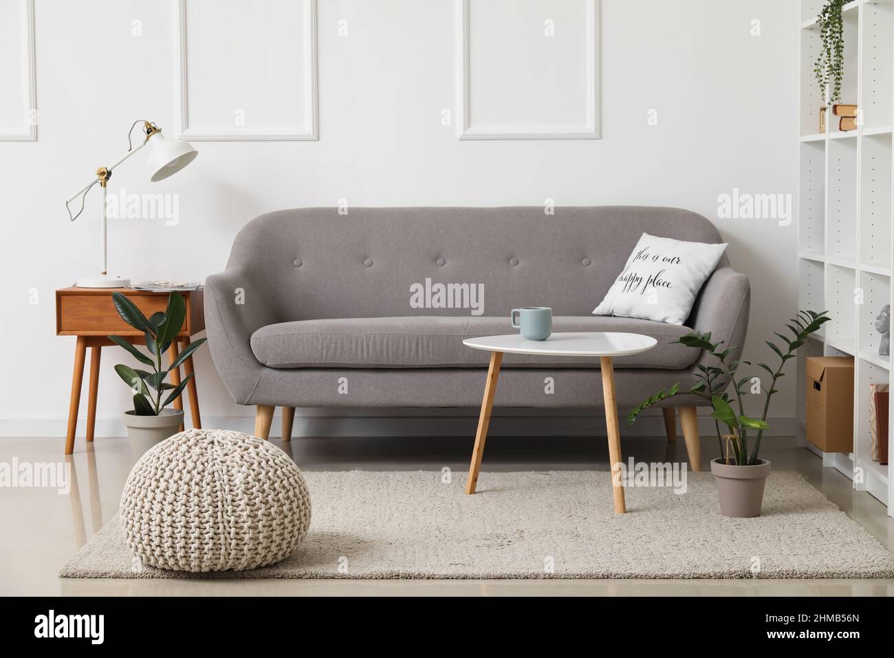 Interior of stylish living room with grey sofa and tables Stock Photo ...
