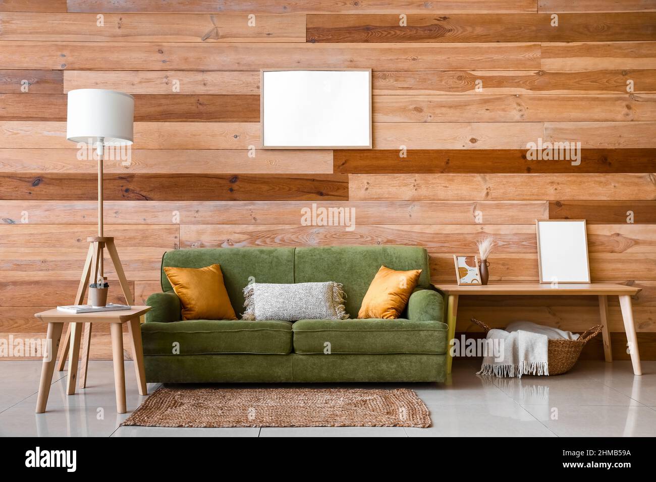 Interior of modern living room with green sofa and coffee tables Stock ...