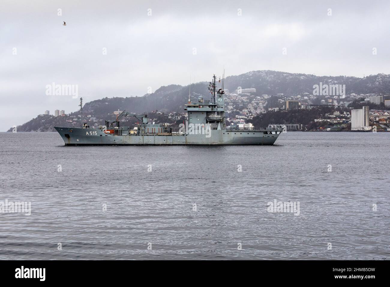German navy replenishment and support vessel Main A515 departing from port of Bergen, Norway.  A dark, rainy and foggy winter day Stock Photo