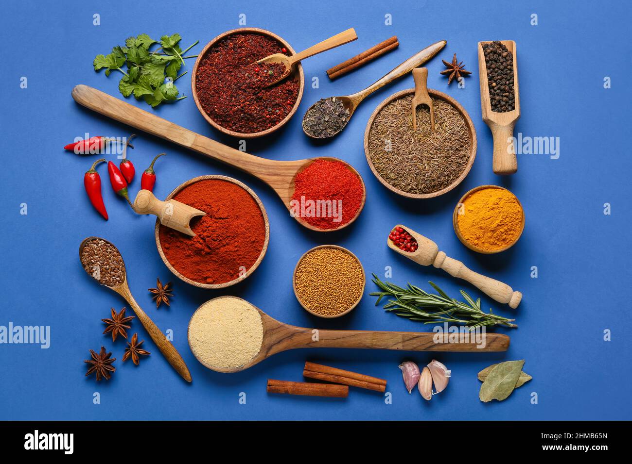 Composition with different spices and herbs on blue background Stock Photo