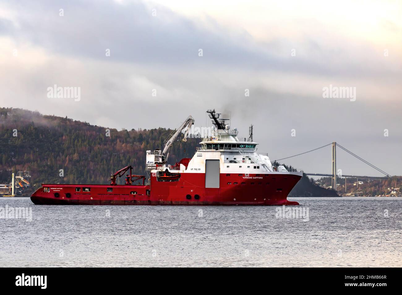 Offshore AHTS anchor handling tug supply vessel Normand Sapphire on Byfjorden, outside port of Bergen, Norway.  Askoy suspension bridge in background Stock Photo
