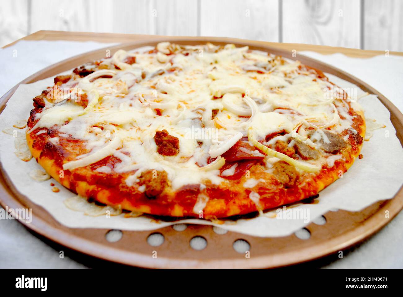 Hot fresh meat lovers pizza pie with onions hires stock photography