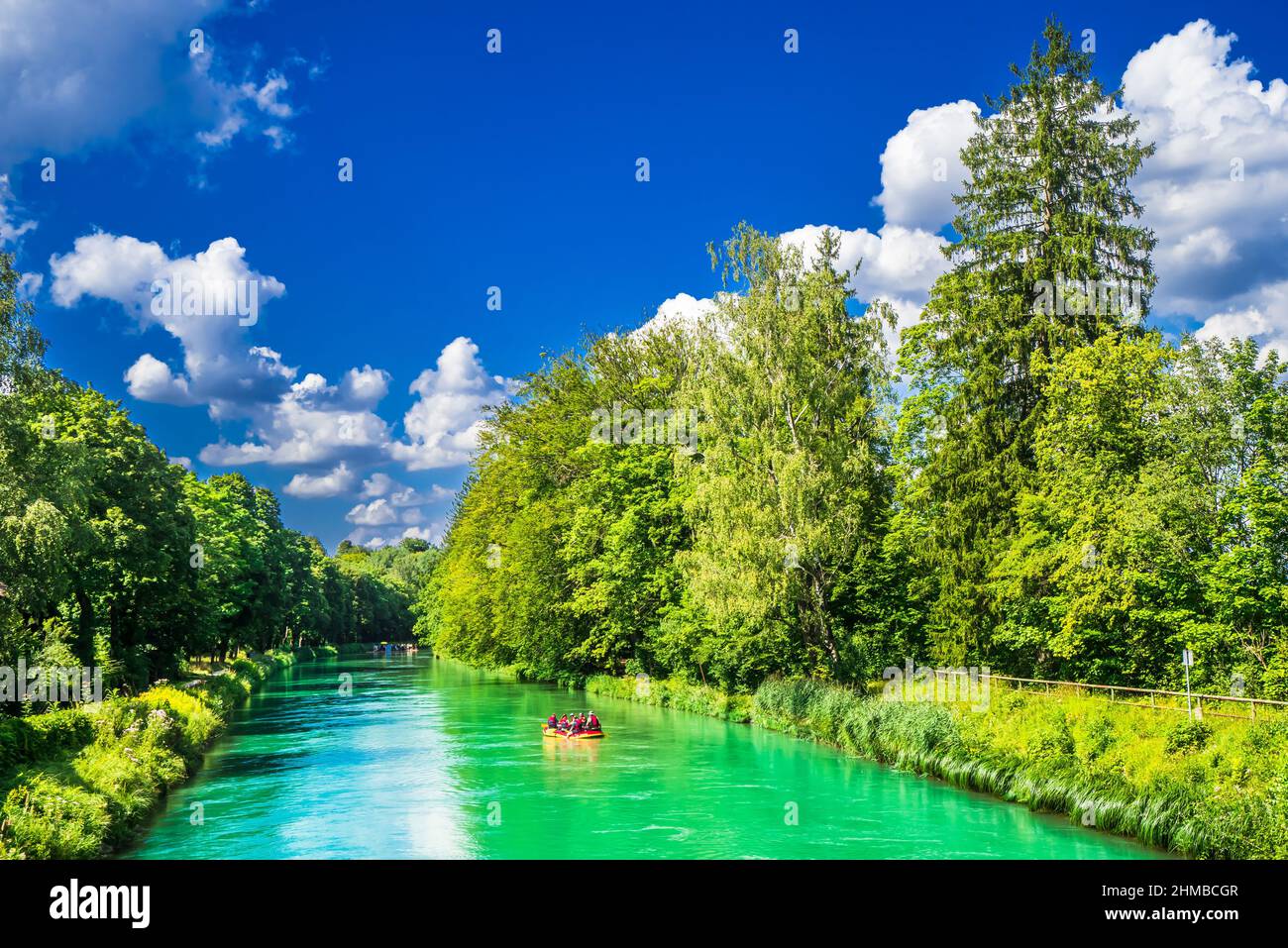 View on people doing rubber dinghy on Isar canal in Munich Stock Photo