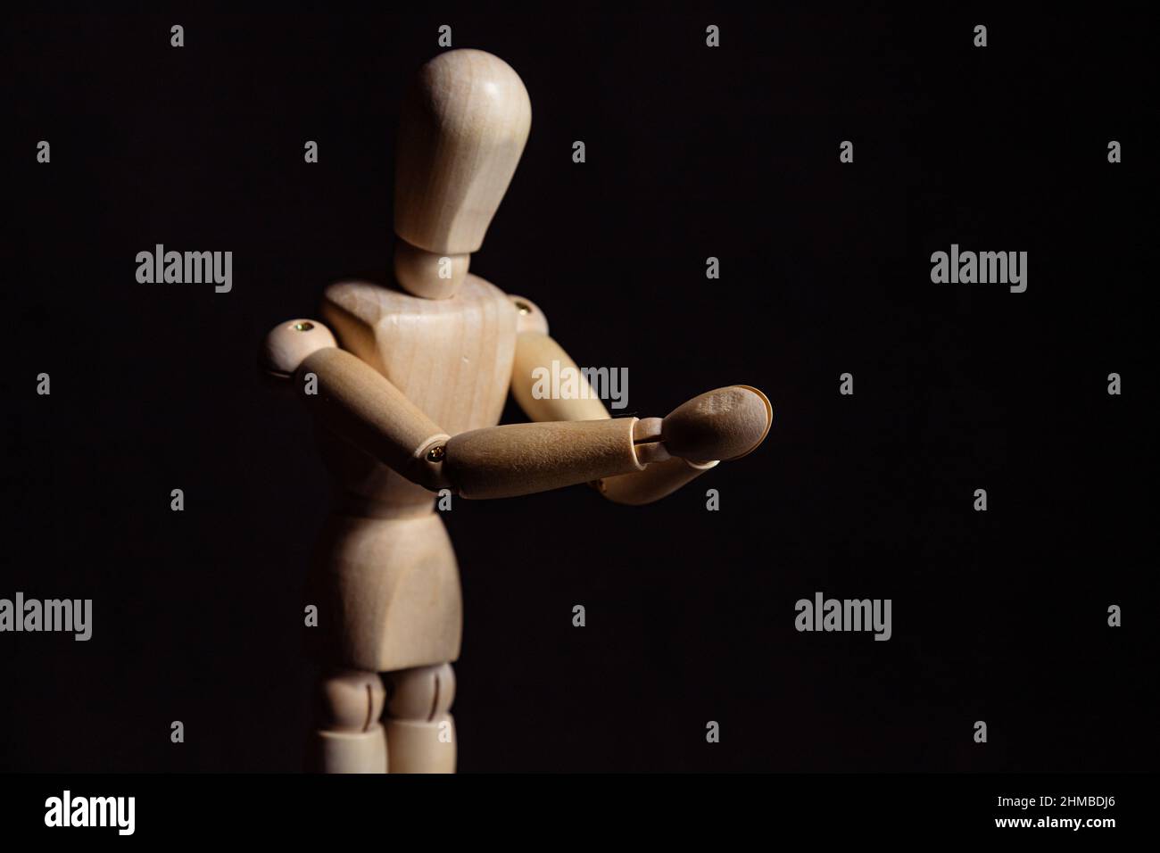 Wooden mannequin with folded hands. Symbol of prayer and religiosity Stock Photo