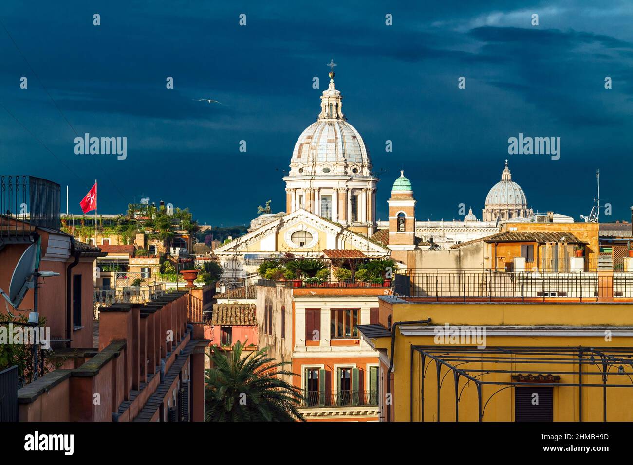 Landscape from Pincio Hill on roofs and churches of the ancient city of Rome. Far away St. Peter's Basilica. Stock Photo