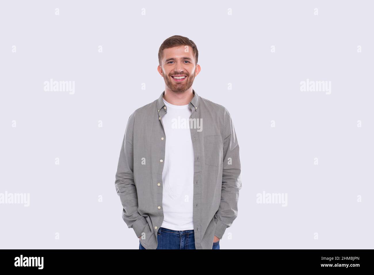 Man Standing Isolated Smilling Hands in Pockets Stock Photo
