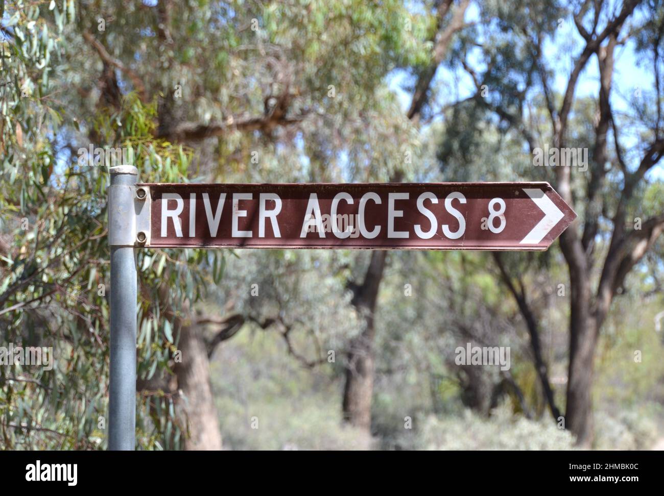 Information sign in the Australian bush with an arrow on a sign post that says River Access and points to the Murray RIver boat ramp near Merbein Stock Photo