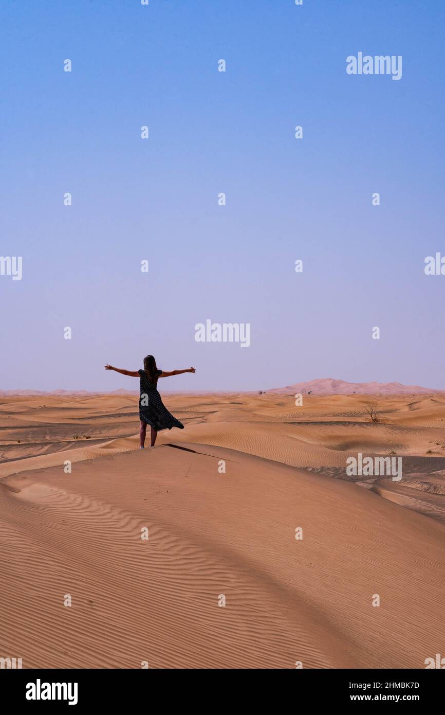 woman in long black dress, freedom in the desert Stock Photo