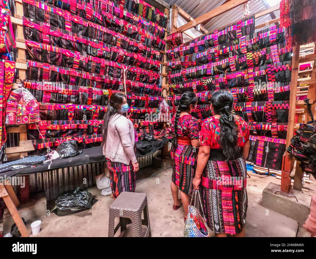 Mayan women shopping for textiles at the Sunday Market in Chichicastenango, Guatemala Stock Photo