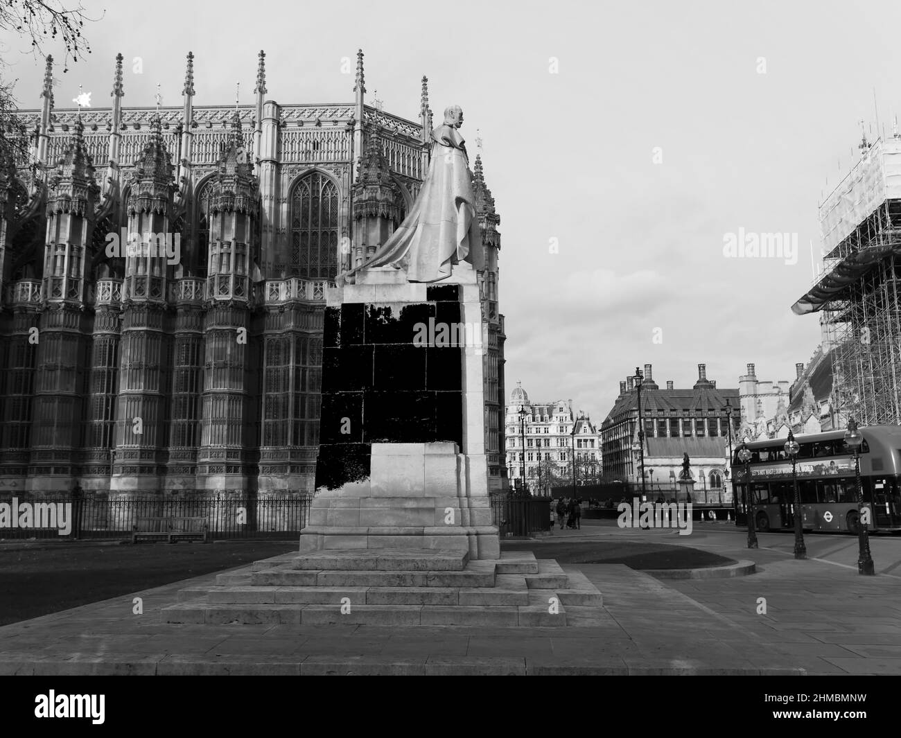 London, Greater London, England, February 05 2022: Side view of the Statue of King George V with Westminster Abbey behind. Stock Photo