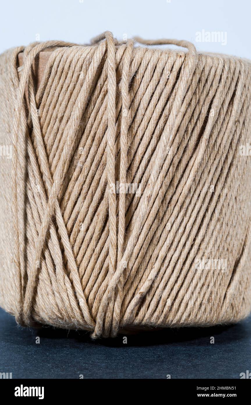 A cardboard cylinder is wrapped with string or twine Stock Photo Alamy