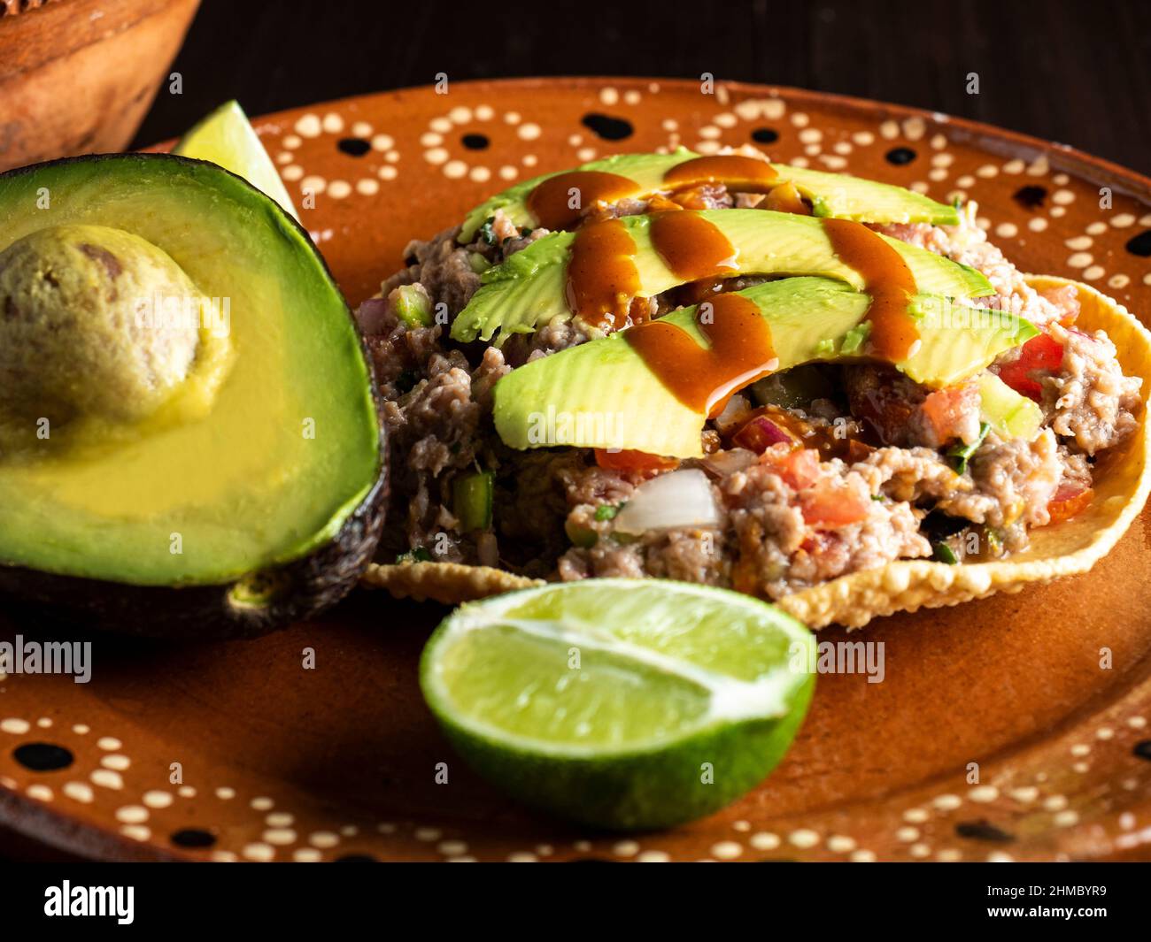 Ground beef tostadas and Mexican sauce and avocado Stock Photo Alamy