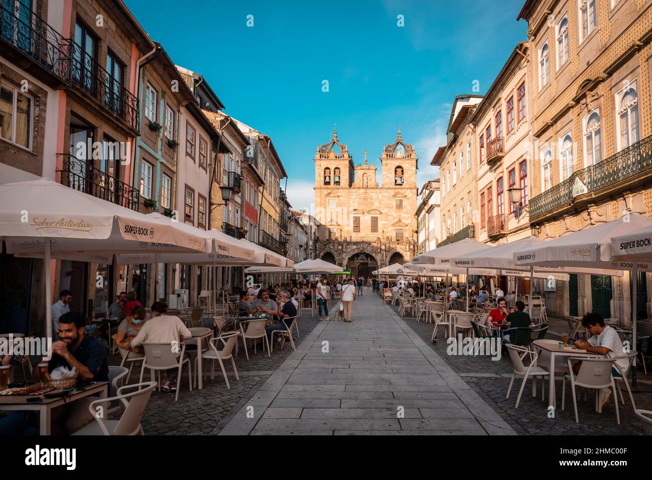Braga, Portugal; August 31th, 2021: Pedestrian street in Braga full of open-air bars, with the cathedral in the background Stock Photo