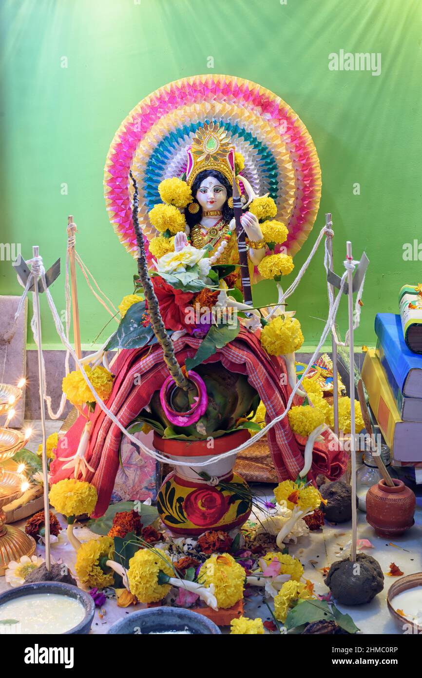 Picture of Goddess Saraswati idol with religious offering, Saraswati symbolizes creative energy and is considered as the goddess of knowledge, music, Stock Photo