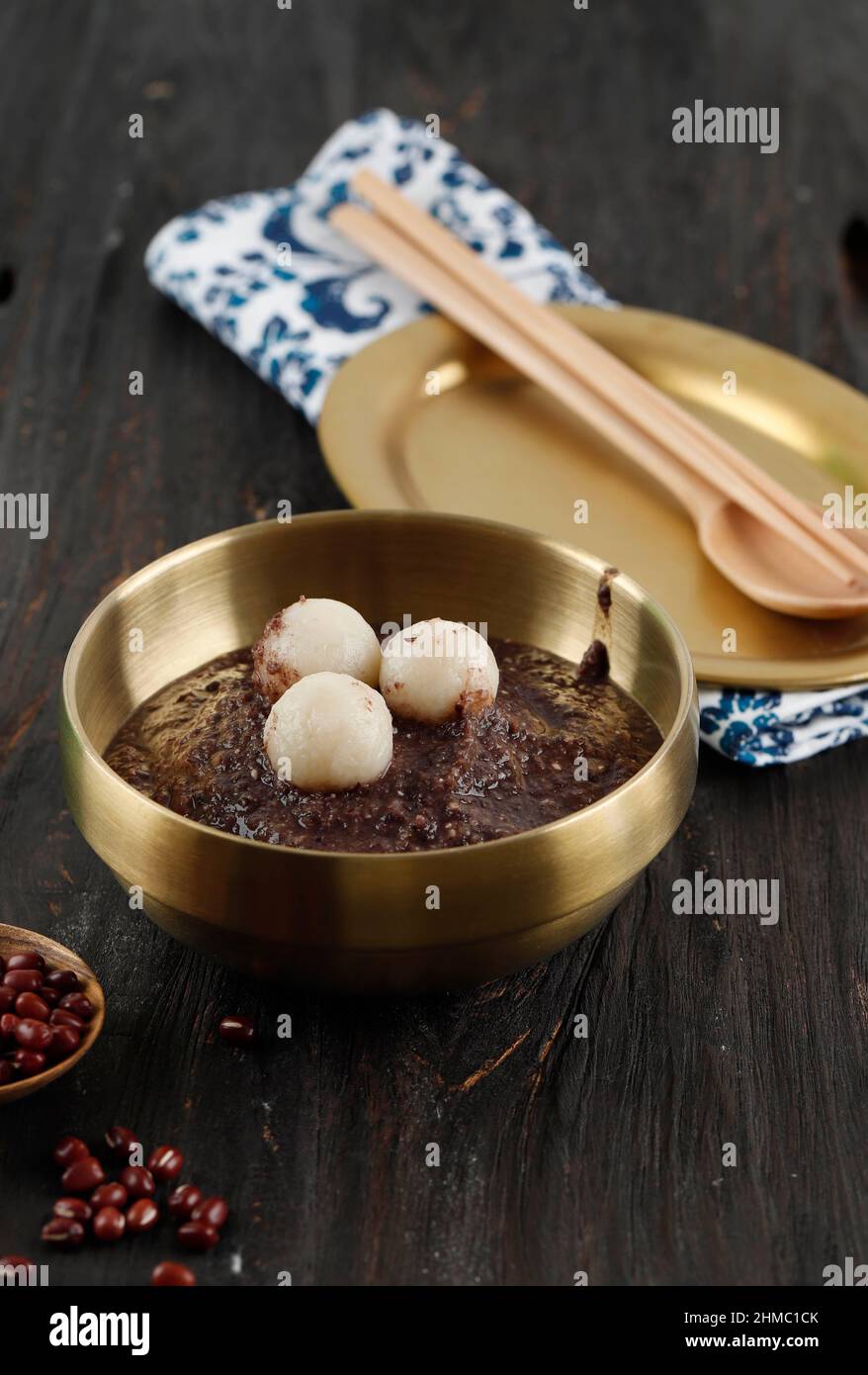 Korean Dongji Red Bean Porridge with Rice Cake, on Wooden Table Stock Photo