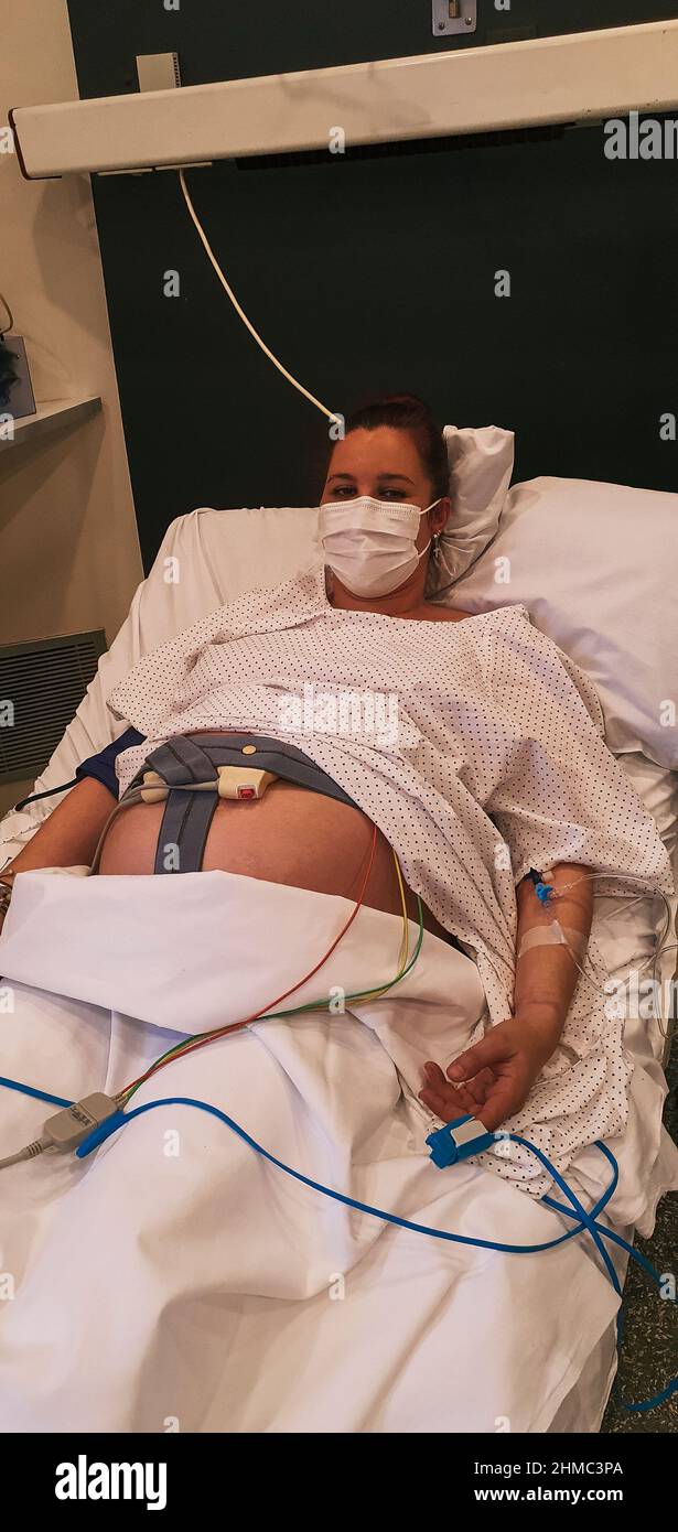 pregnant young woman dilating in delivery room, waiting to give birth at hospital Stock Photo