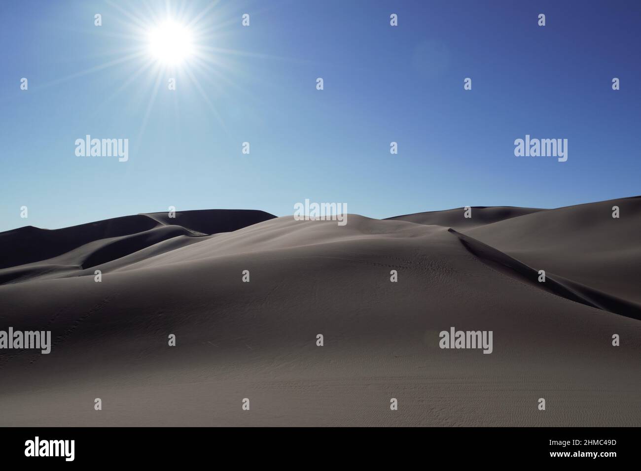 Sun glory above desert dunes Stock Photo