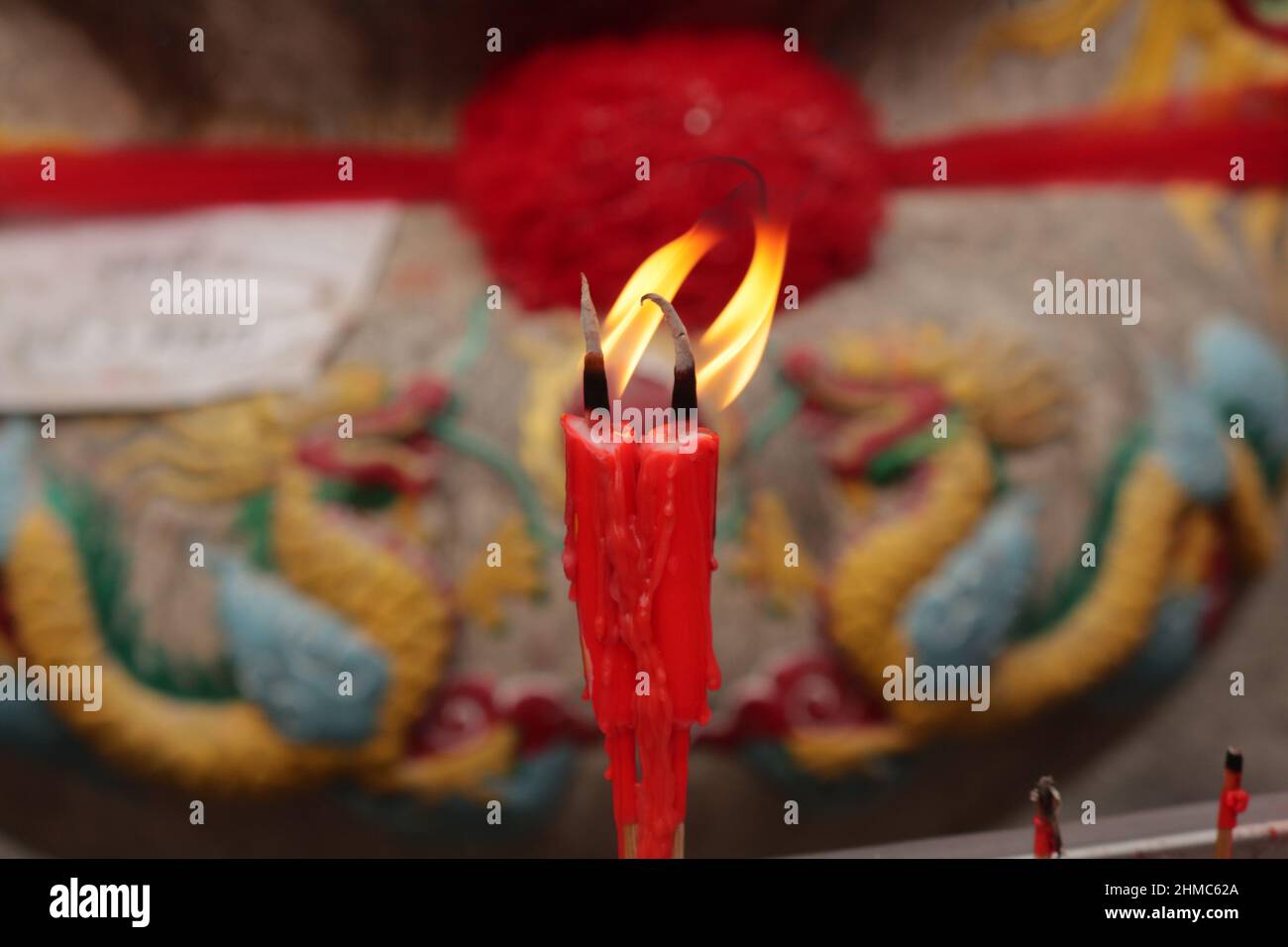 Two  candles burn  as offerings in a Temple, Chinatown, Bangkok,Thailand Stock Photo