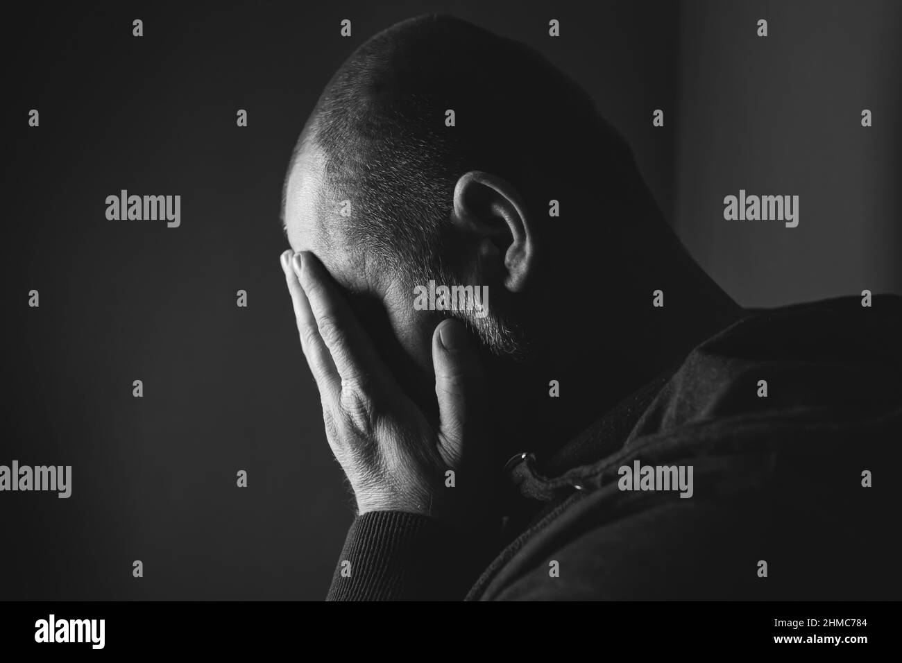 Man sitting in dark room Black and White Stock Photos & Images Alamy