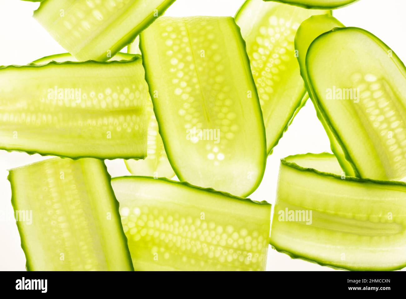 Beautiful fresh transparent cucumber slices on white background Stock Photo