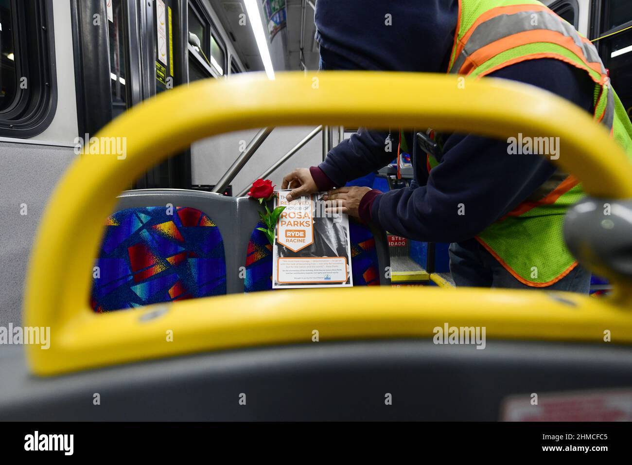 Racine, Wisconsin, USA. 3rd Feb, 2022. JosÃ © Lopez places placards and roses honoring Rosa Parks on two dozen RYDE Racine city transit buses in Racine, Wisconsin Thursday evening February 3, 2022 in preparation for the morning bus commute on Rosa Parks Transit Equity Day, celebrating the civil rights heroÃ¢â‚¬â„¢s birthday. One seat on each bus is being symbolically reserved for Parks who was instrumental in the Montgomery, Alabama bus boycott in 1955-1956. (Credit Image: © Mark Hertzberg/ZUMA Press Wire) Stock Photo