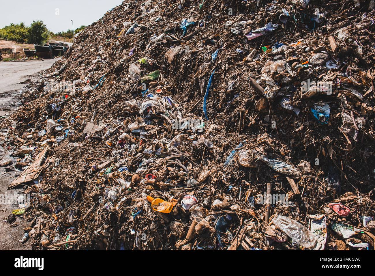 Bad quality organic waste polluted with plastic garbage at city waste