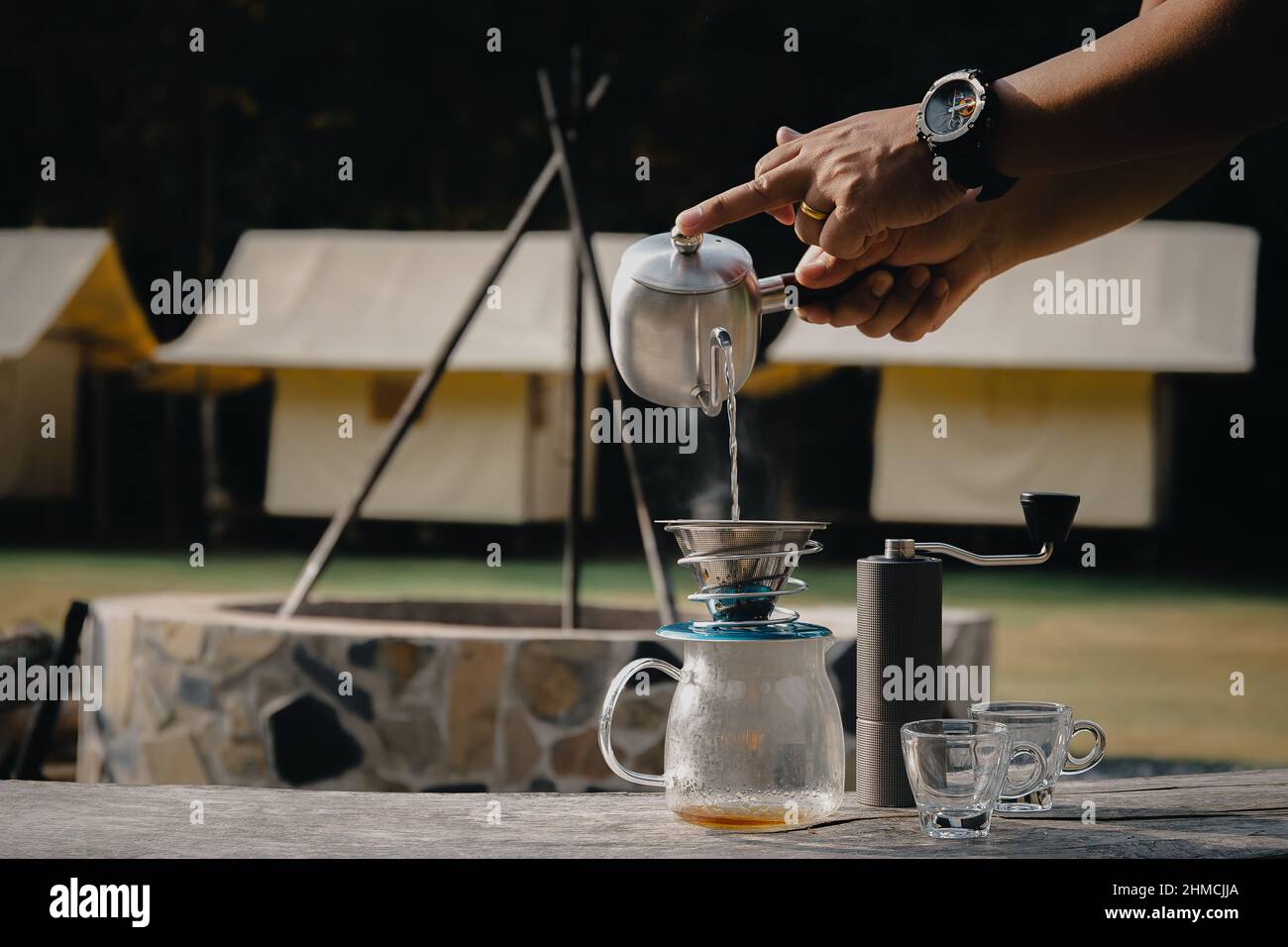 Drip coffee man pouring hot water on coffee ground with filter. Stock Photo