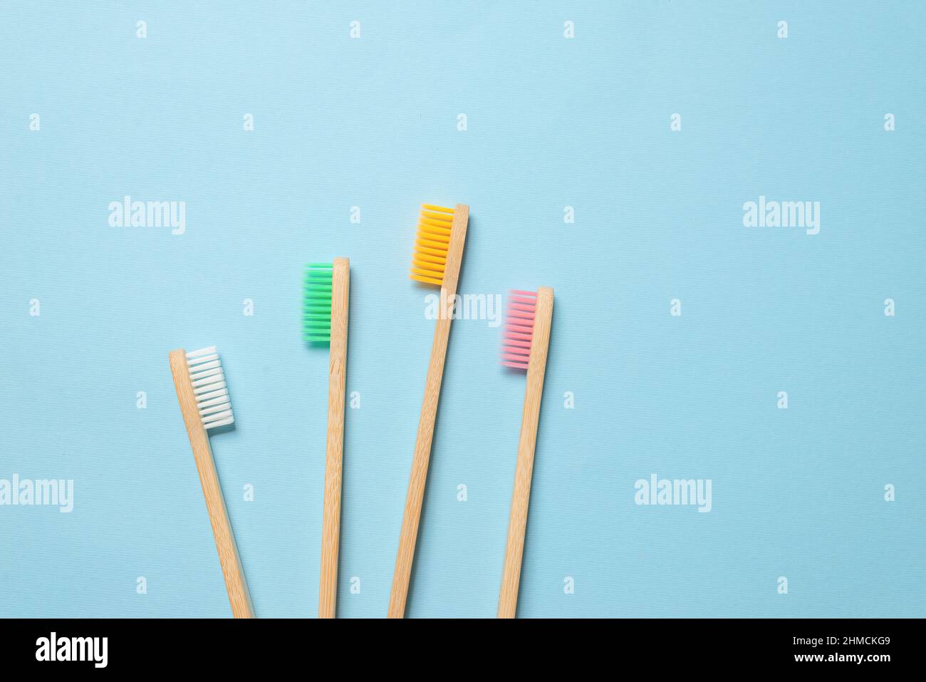 Bamboo toothbrush on a blue background. Top view Stock Photo - Alamy