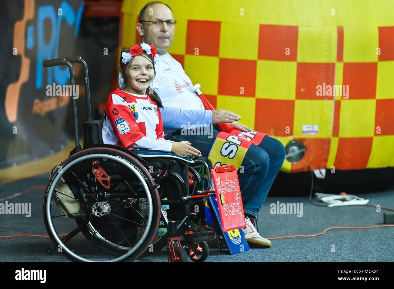 LUBIN, POLAND - NOVEMBER 23, 2021: Polish PGNiG Superleague men handball match between MKS Zaglebie Lubin - Chrobry Glogow.  A disabled smiling girl i Stock Photo