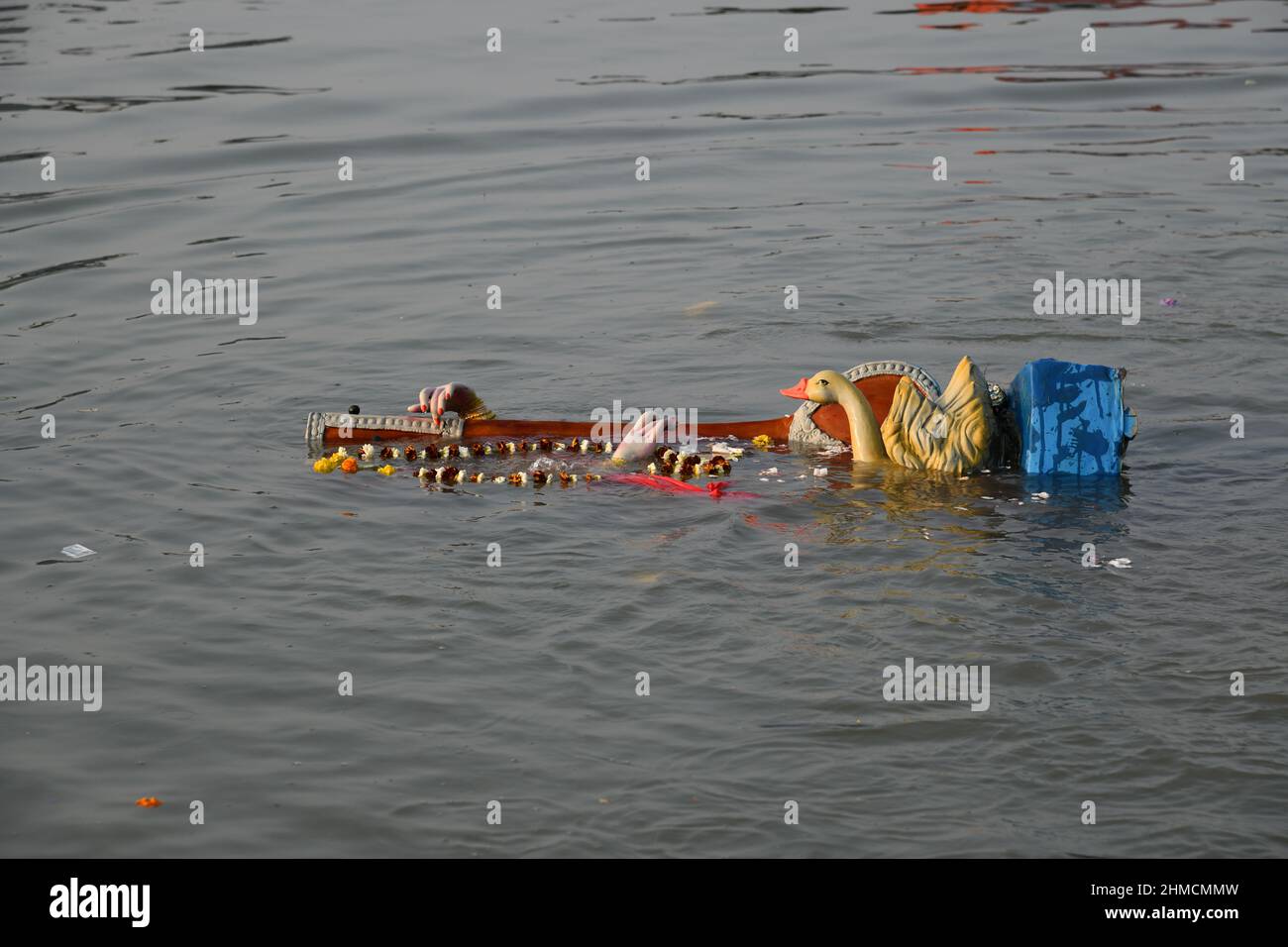 Floating Hindu goddess Saraswati idol for immersion on the Ganges after