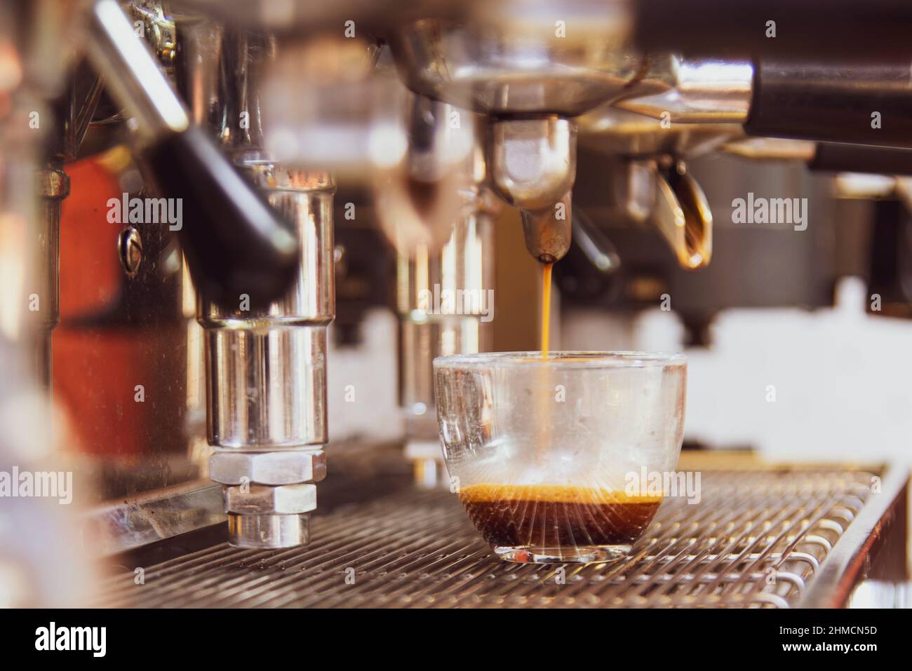 Close-up of espresso pouring from the coffee machine. Professional ...