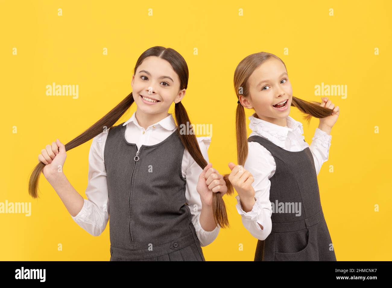 For creative learning. Happy children hold long hair. Beauty school