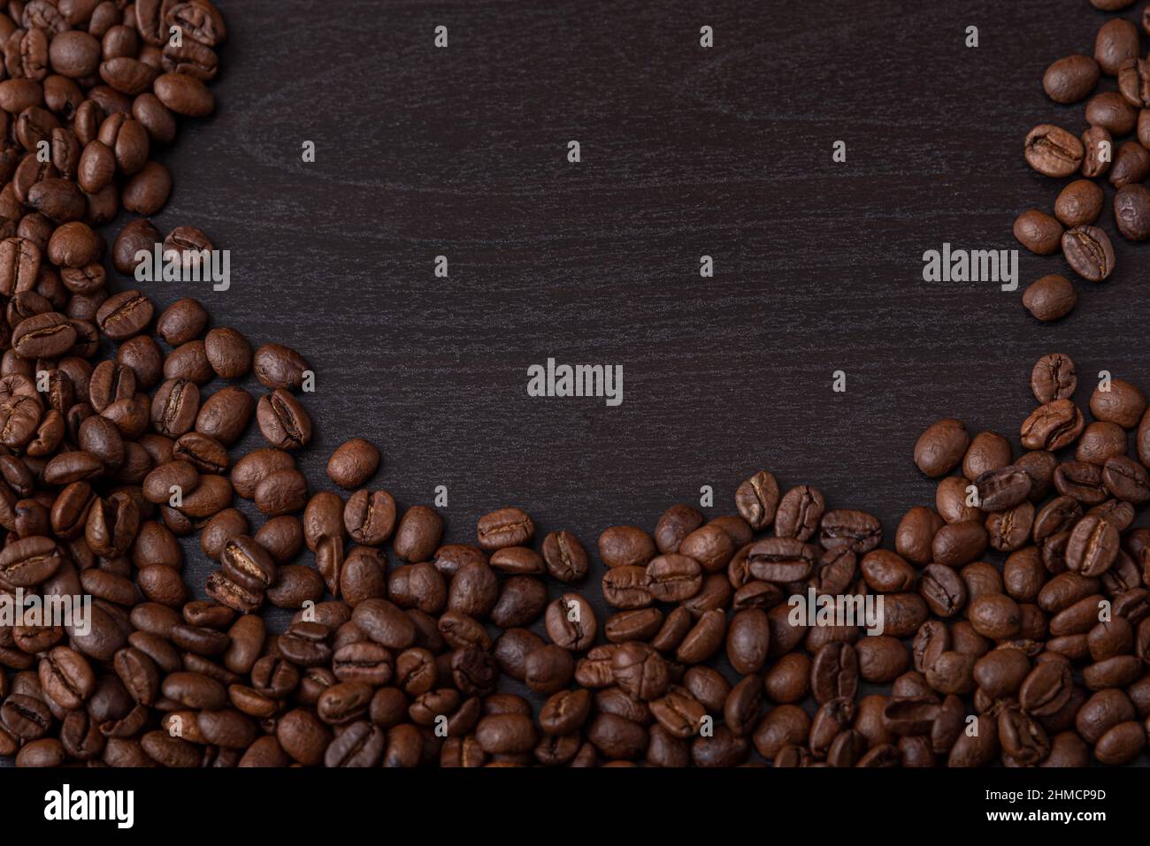 roasted coffee beans on black wood background Stock Photo