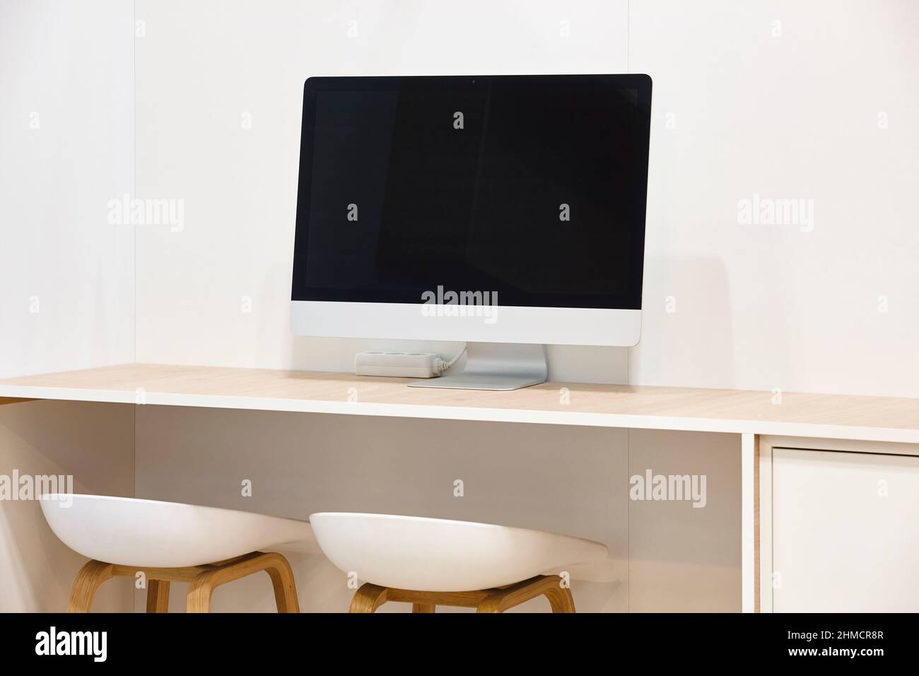 Computer desktop and stools. Minimalist indoor work place. Nobody Stock ...