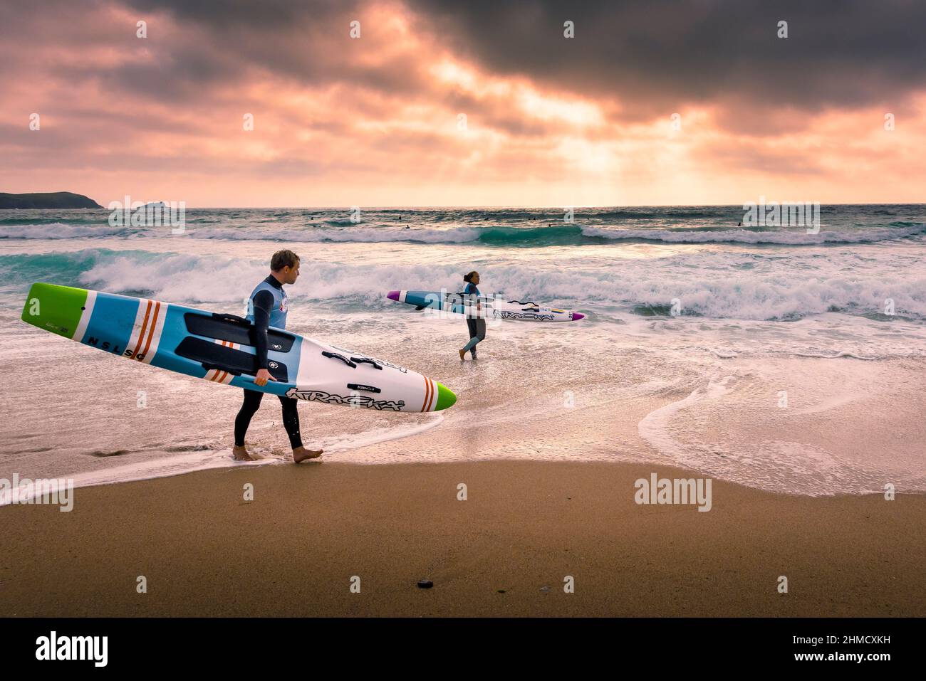Late evening light over members of Newquay Surf Lifesaving Club at a training session on Fistral Beach in Newquay in Cornwall. Stock Photo