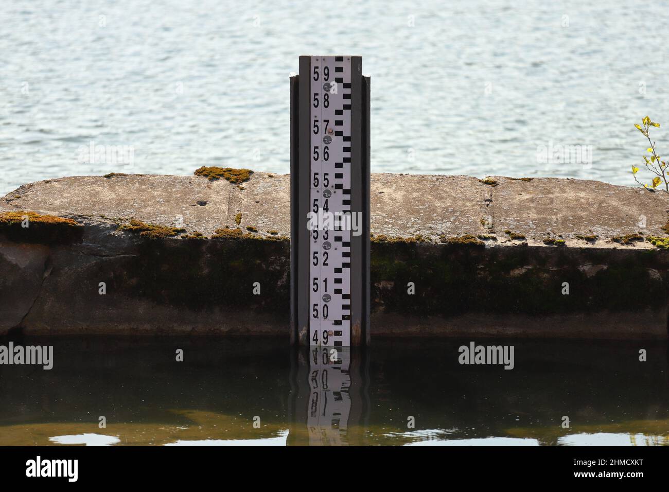 Water depth measurement tool on the lake shore.Observation of the water level scale to prevent floods and disasters Stock Photo