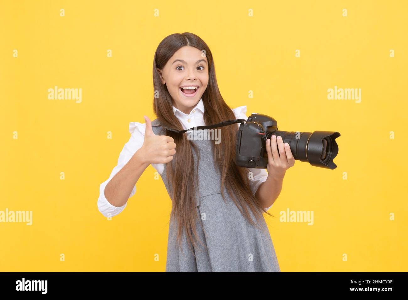happy teen girl photographer use digital photo camera show thumb up, photographing Stock Photo