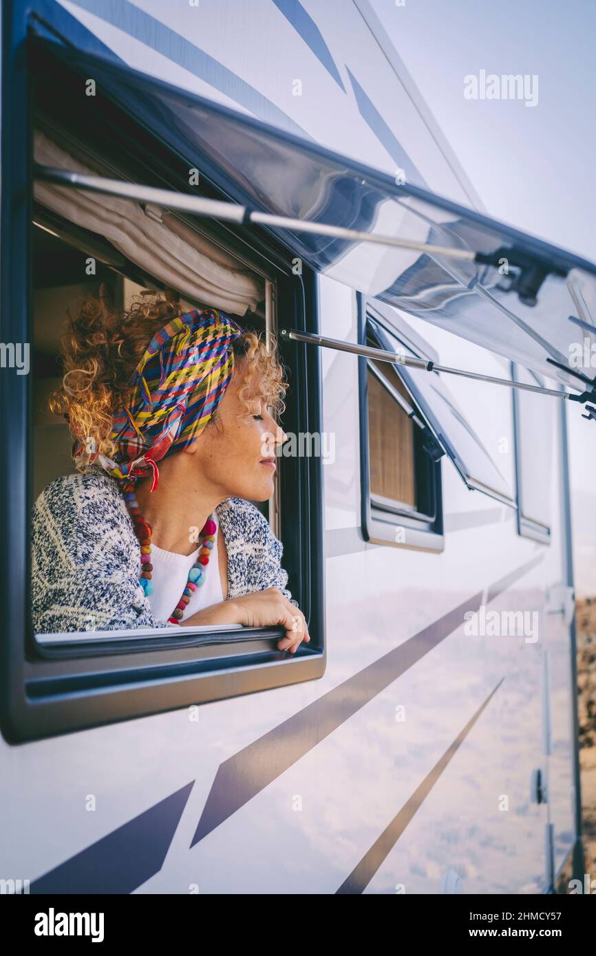 People tourist enjoy freedom with camper van travel summer holiday vacation lifestyle. Happy woman outside the motorhome window with closed eyes feel Stock Photo