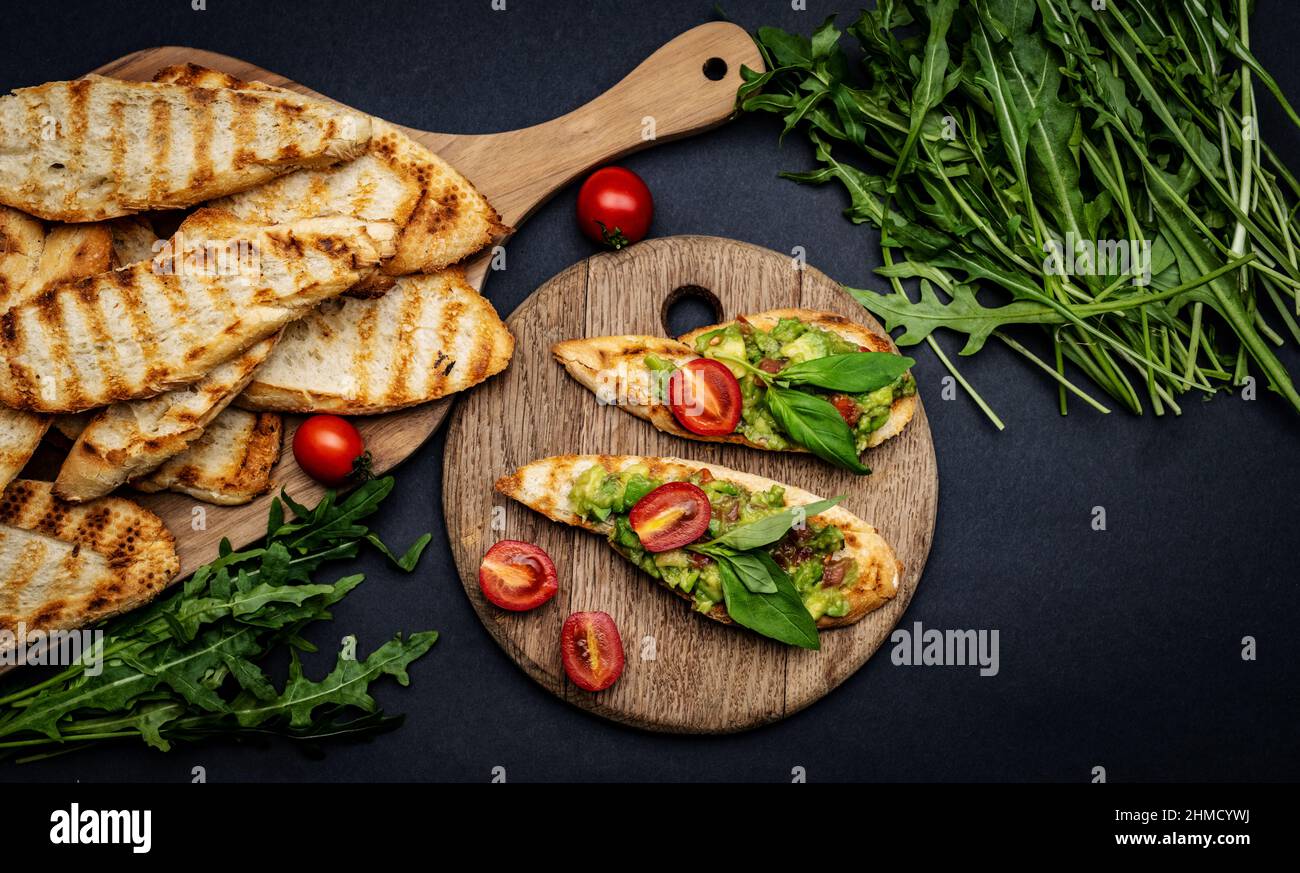 Bruschettas with guacamole and cherry tomatoes Stock Photo