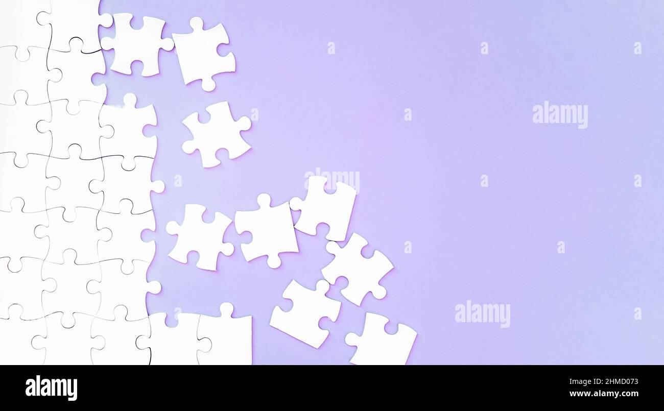 Puzzle pieces on pink background Stock Photo