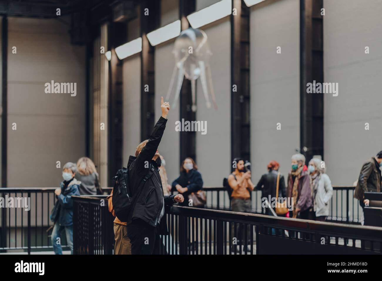 London, UK - October 23, 2021: Man watches aerobes of Anicka Yi's installation In Love With The World in Turbine Hall of Tate Modern,a museum in Londo Stock Photo