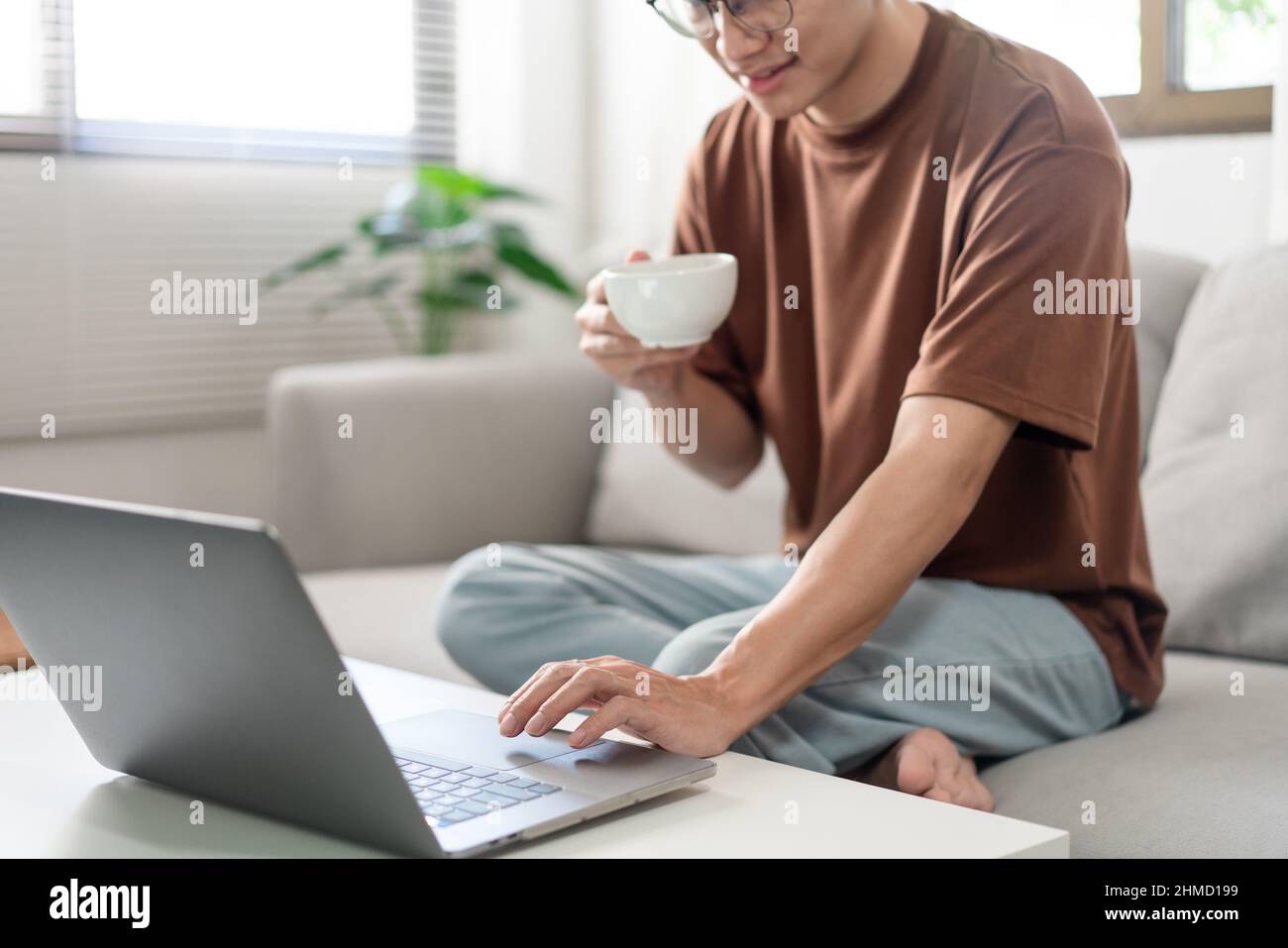 Technology Concept The man in brown T-shirt using one hand typing on ...