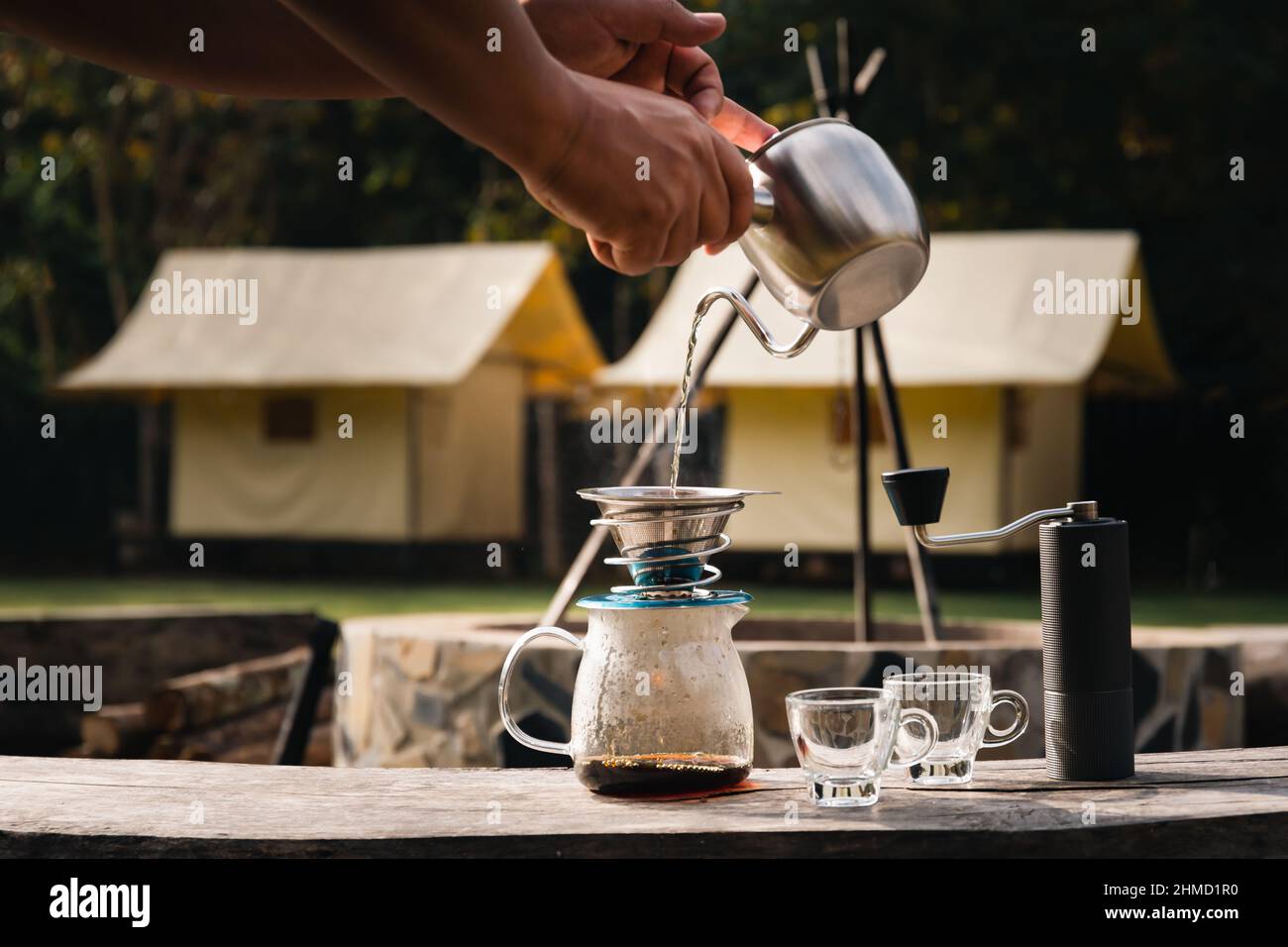 Drip coffee man pouring hot water on coffee ground with filter. Stock Photo