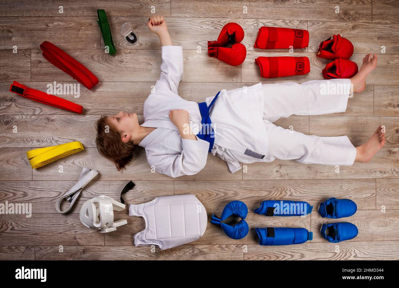 Conceptual image in flat lay style of a little karateka girl surrounded by her equipment necessary for training and competition Stock Photo