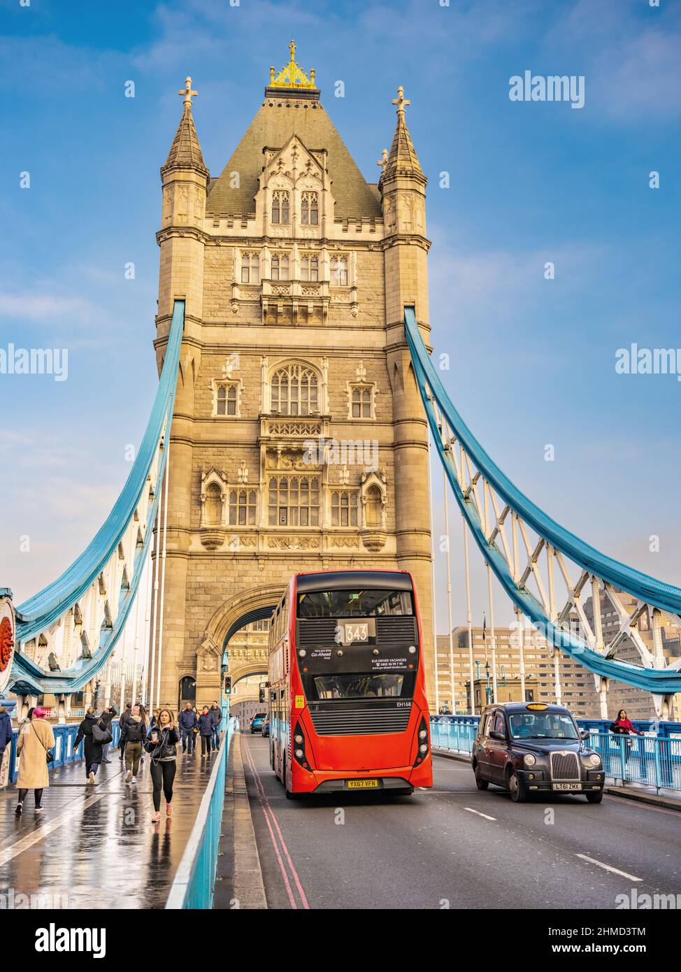 Tower Bridge, black cab and red bus. wet weather reflection. Stock Photo