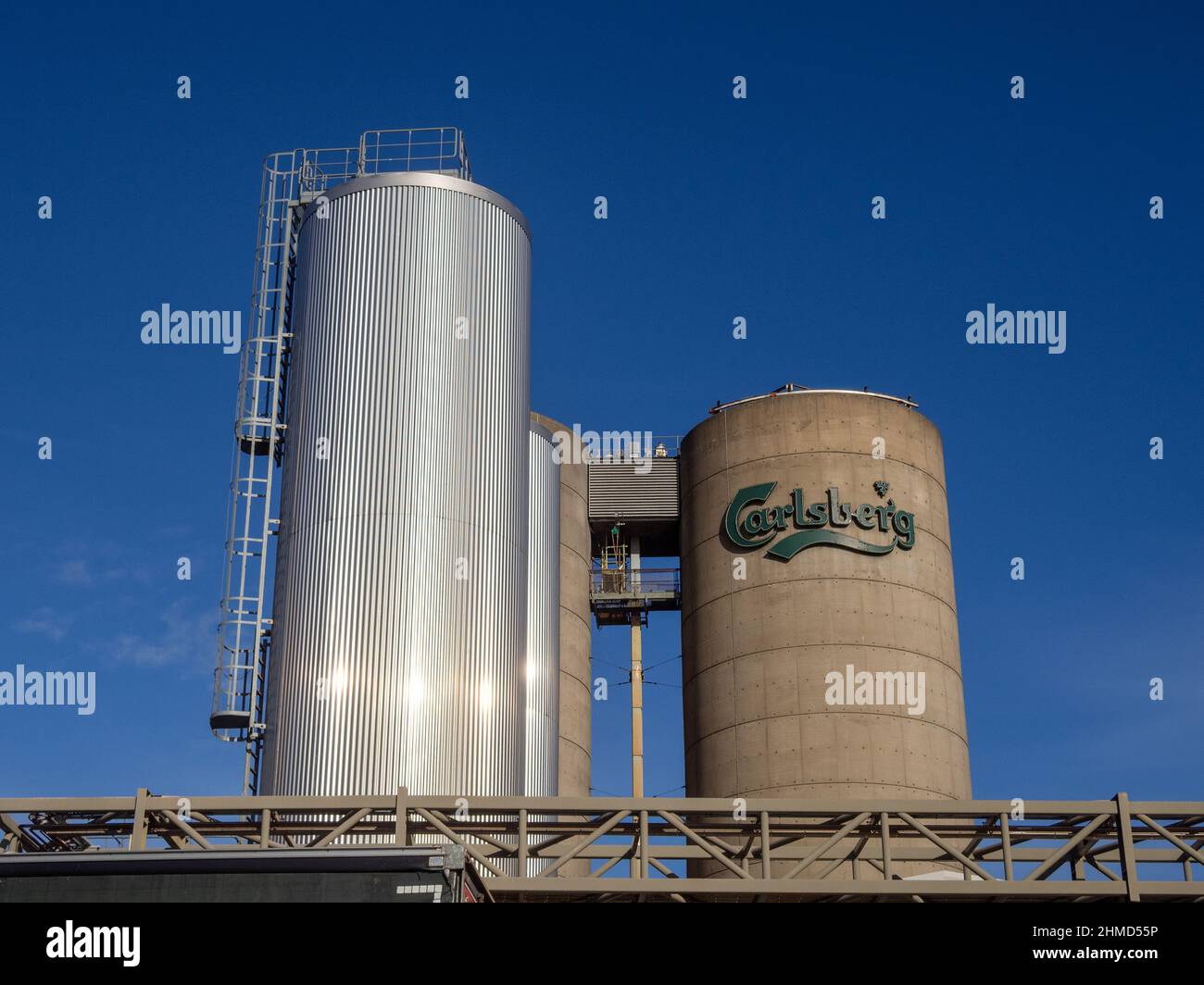 Storage vats and chimney, part of the Carlsberg Brewery complex, Northampton, UK Stock Photo