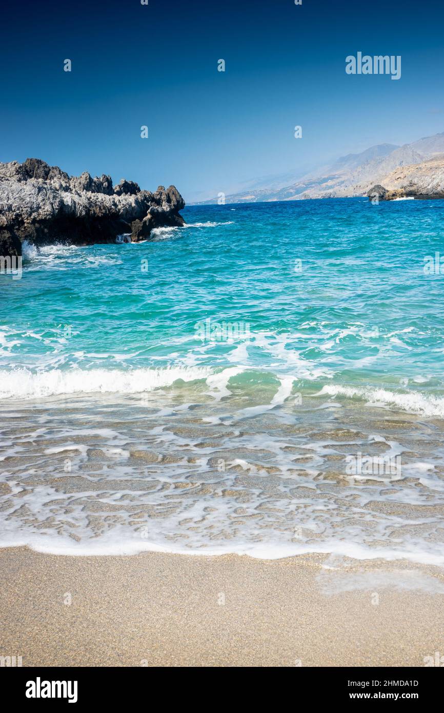 Foamy waves on blue sea water on sunny day Stock Photo